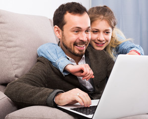 Father and daughter booking hotel online