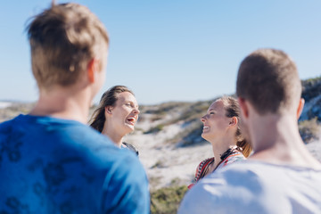 Two sisters enjoying a good laugh on a beach