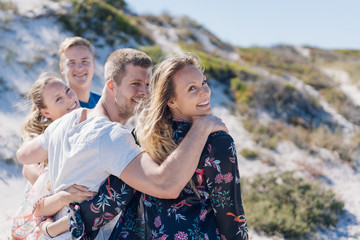 Group of young friends walking on a beach