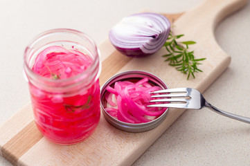 Pickled red onions in vinegar. Pickling red onions is easy, simply marinate the onions in a brine with vinegar, salt and herbs. Pickled food can be preserved in glass jar for a very long time!