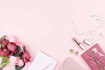 Obraz na płótnie Canvas Beauty blog concept flat lay. Fashion accessories, flowers, cosmetics, jewelry on pink background, copyspace.
