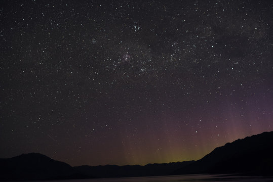 Paisaje montañoso con cielo nocturno repleto de estrellas en Nueva Zelanda.
