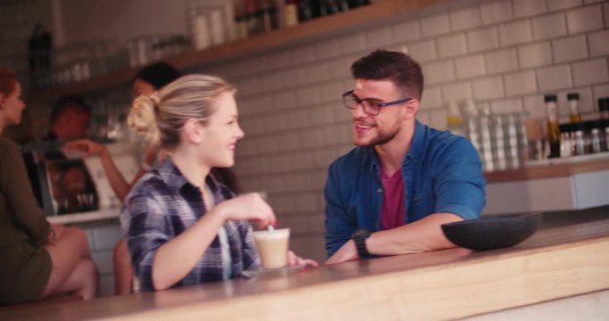 Young hipster friends having fun in urban coffee shop