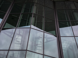 The glass architecture in city against a sky
