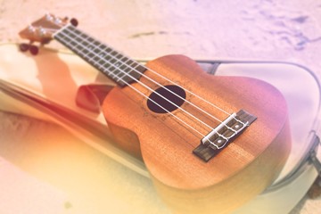 Fototapeta na wymiar Ukulele guitar on a sand close up