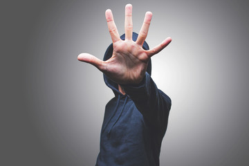 view of a man showing his hand hiding his face