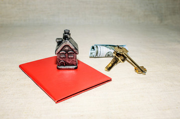 Home, keys and money on the table. The concept of a mortgage loan.