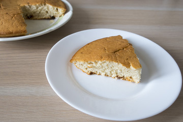 A nice and appetizing piece of homemade cake and a cupcake.