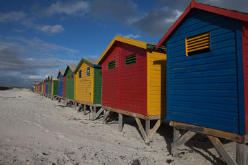 Brightly colored beach huts in South Africa