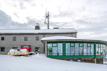 Cable railway station and snowplow on the mountain top Wallberg covered with snow, Bavarian Alps, Bavaria, Germany