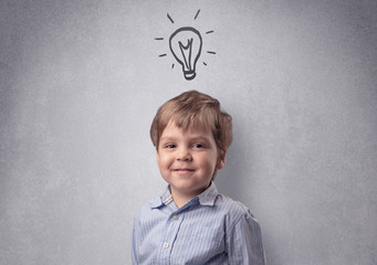 Smart little junior in front of a drawn up grey wall with childlike concept