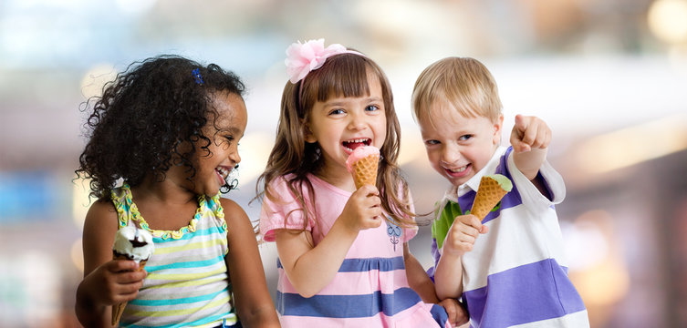 Happy Kids Eating Ice Cream At A Party In Cafe