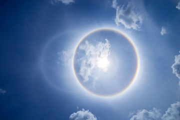 Naklejka na ściany i meble sun corona rainbow clouds and blue sky background , Circumscribed halo