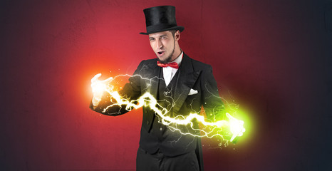 Magician sparkling super power between his two hands