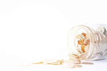 Business, finance, saving money or investment concept : Coins scattered from glass jar on white background