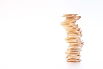 Business, finance, saving money or investment risk concept : coins stack on each other in different positions on white background