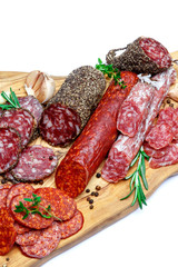 Various types of Dried organic salami sausage on wooden cutting board