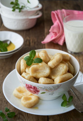 Cottage cheese vareniki with butter in a bowl