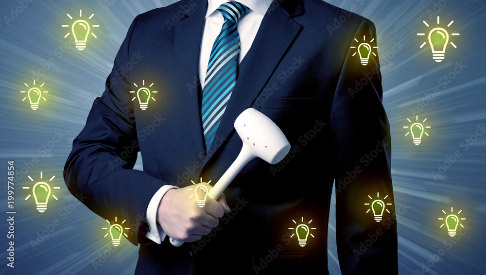 Wall mural Better-looking businesman holding tool with idea bulbs concep