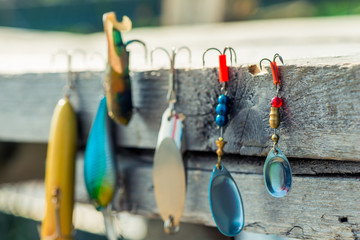 close-up of baubles and hooks for fishing close-up on a wooden pier