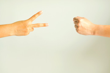 Two person playing rock paper scissors.