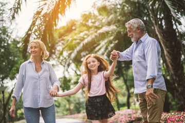 Fototapeta premium mother and daughter father family playing and walking around the park on beautiful morning.