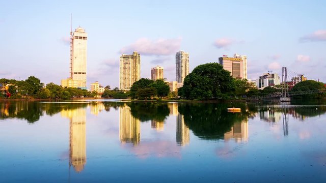 Sri Lanka. View of Beira Lake in Colombo, Sri Lanka with buddhist temple and modern buildings at sunrise. Morning time-lapse. Clear sky