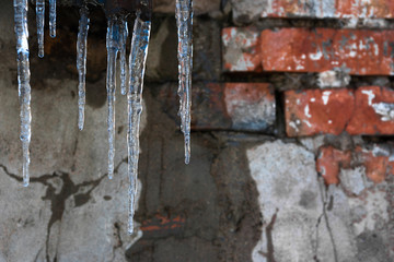 Blue icicles against a dirty wall