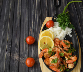 Roasted shrimps with lemon, garlic,herbs and white rise, seafood shelfish shrimps prawns grilled with spices