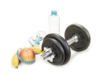 Obraz na płótnie Canvas Dumbbell and an apple with a tape measure, isolated on white