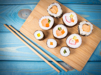 Various kinds of sushi on the blue background.