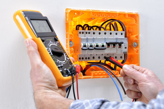 Electrician technician at work on a residential electric panel