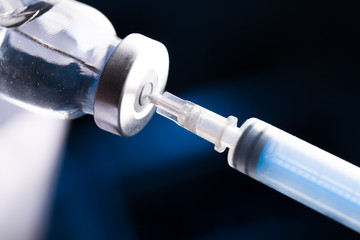 Medical hands holds syringe and vaccine