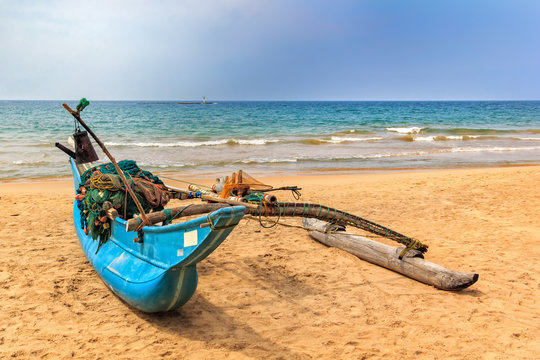 traditional Sri Lankan fishing boat on the shore before going to sea