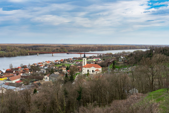 Landscape view of the Batina village at the bank of the Danub river with cargo boats and a bride in spring