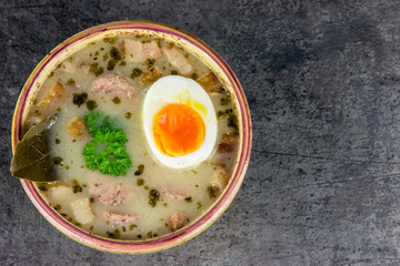 Zurek - polish Easter soup with eggs and white sausage - closeup - copy space