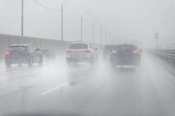 Drive car in rain on asphalt wet road. Clouds on the sky