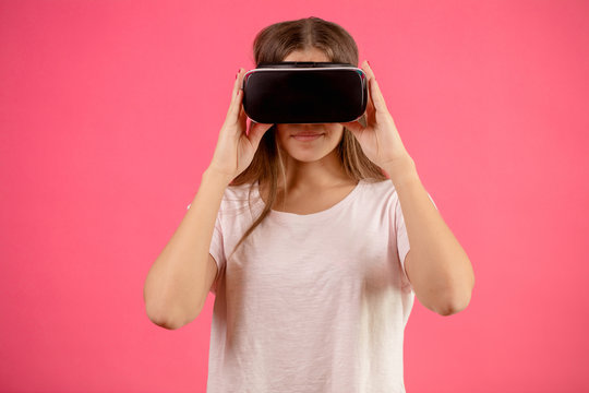 close up portrait of model in white T-shirt using vertual reality googles. touch glasses