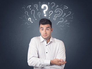 Young casual businessman with white question marks above his head