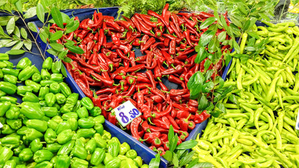 Red and green peppers at market
