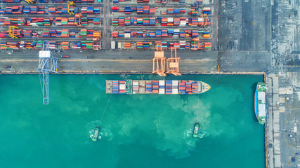 Fototapeta na wymiar Container ship in export and import business and logistics. Shipping cargo to harbor by crane. Water transport International. Aerial view