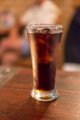 A glass of Cola on the table
