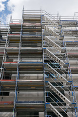 scaffolding near a new house, building exterior, construction and repair industry, white wall and window