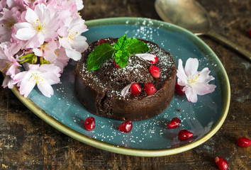 Chocolate pudding garnished with mint and pomegranate