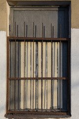 window with a lattice on a yellow white wall is large