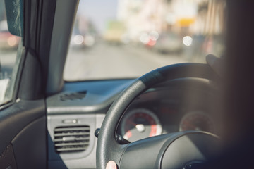 Fototapeta premium Hands of a female driver on steering wheel