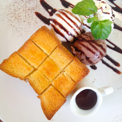Toast and ice cream served with whip cream