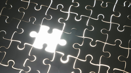 hand holding piece of white jig saw puzzle place to match or completing the final pazzle...