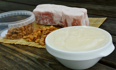 Lard bacon and crackling on wooden background and bamboo background