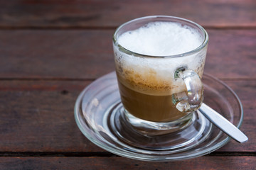 Cappuccino coffee on rustic wood table